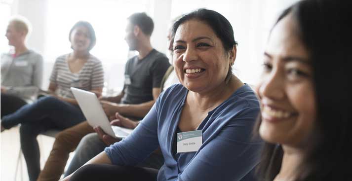 a woman smiling in a meeting
