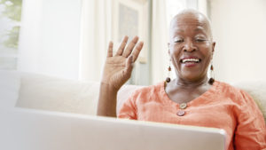 a woman waving on a video call