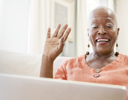 a woman waving on a video call